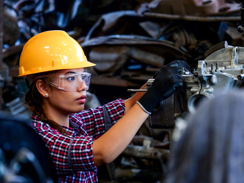 Young Asian Engineer woman  working with machine in factory.